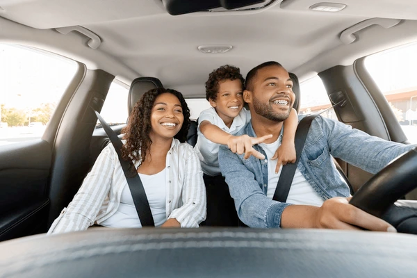 Family car driving safely on the road